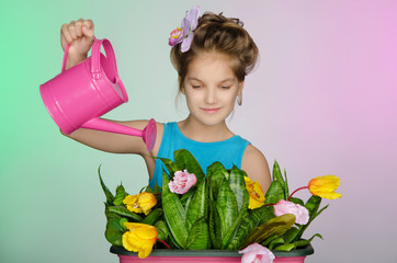 Happy girl watering flowers