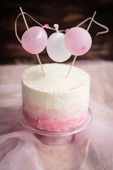 pink / white cake with cream cheese frosting. 