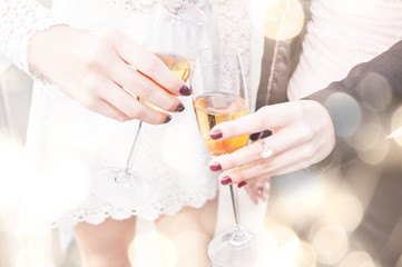 Champagne toast.Two young woman celebrating with champagne.