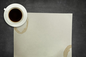 Obraz na płótnie Canvas Black blackboard background with coffee cup and empty paper