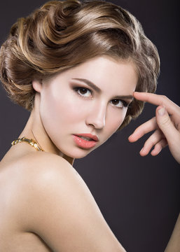 Beautiful girl with evening hairstyle and bright makeup