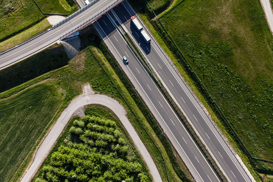 aerial view of highway and green harvest fields