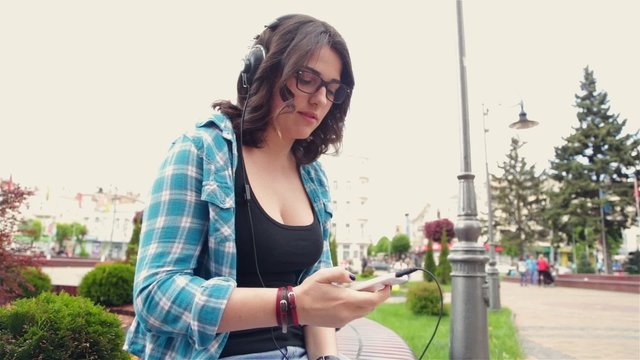 Woman wearing headphones listening to music and having fun