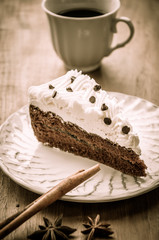 Slice piece of vanilla cake topping with white chocolate chips 