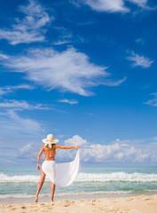 Woman in sarong on the beach