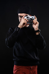 Charismatic guy in sweater , glasses  photo camera