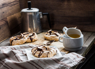 meringue cake with chocolate, caramel and nuts, dessert, rustic