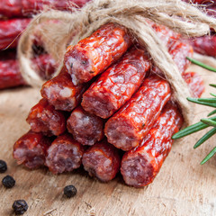 Snack stick sausage on rustic wood