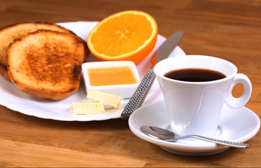 breakfast: cup of coffee, toasts, jam, butter and orange