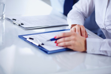 Image of business team sitting at the table and discussing a new