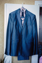 Front view of a Mens wool pinstripe suit jacket with tie and