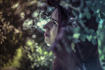 Tears, melancholy young girl in a forest with sad gesture