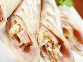 rolled pancakes stuffed ham and cheese.