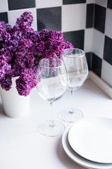 lilacs in a vase and glasses