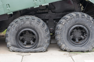 Fototapeta na wymiar Flat tire of military vehicles