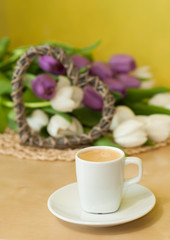 tulips on the table with cup of caffee