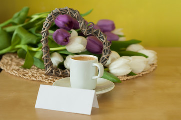 tulips on the table with cup of caffee