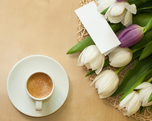 tulips on the table with cup of caffee