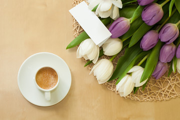 tulips on the table with cup of caffee