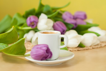 Fototapeta na wymiar tulips on the table with cup of caffee
