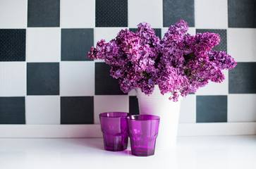 lilacs in a vase and glasses