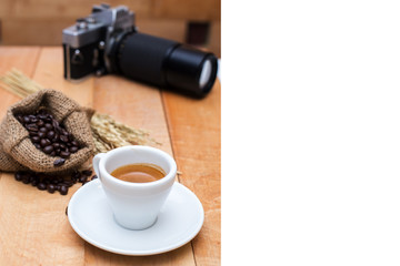 Hot coffee and coffee beans and camera vintage on a wooden table
