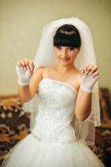 Obraz na płótnie Canvas beautiful bride getting ready in white wedding dress with