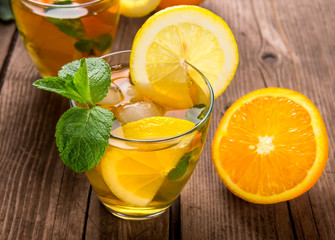 Lemonade with fresh lemon and mint on wooden background
