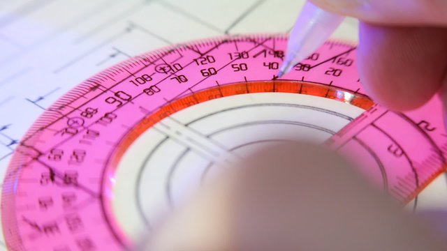 Red protractor and pencil draws a line