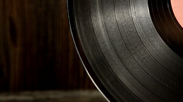Various old vinyl records on the old wooden background