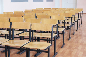 Rows of wooden chairs in the hall