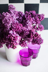 lilacs in a vase and glasses