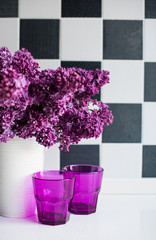 lilacs in a vase and glasses