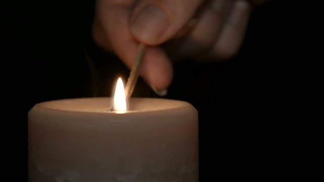 Match lighting a candle