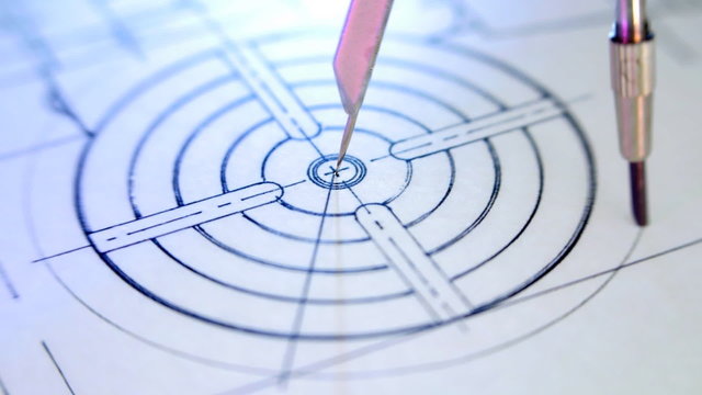 Compasses draws circle on the drawing