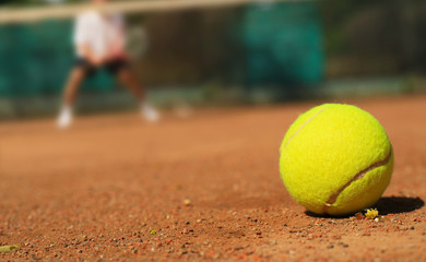 Tennis tennis ball on the ground and the player
