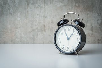 Old-time alarm clock on a white table