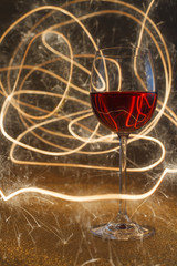 rose wine glass on glitter lit by sparkling sticks