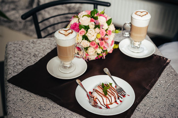 Hands of bride and groom. Cappuccino or latte coffee with heart