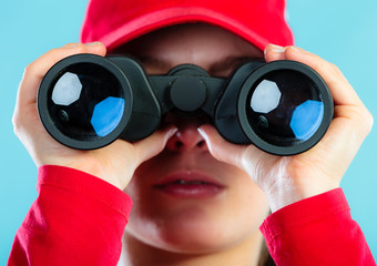 lifeguard on duty looking through binocular
