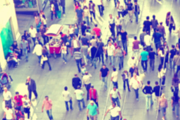 Background with blurred people walking on the street
