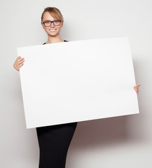 business woman holding a blank billboard.