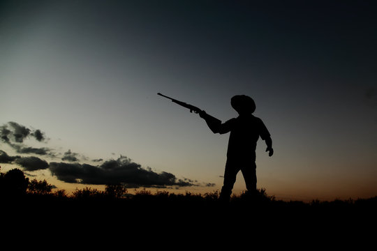 Silueta de cazador vaquero al atardecer