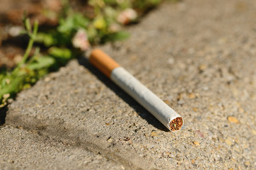 Cigarette on asphalt