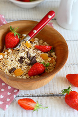 granola with ripe strawberries in a bowl
