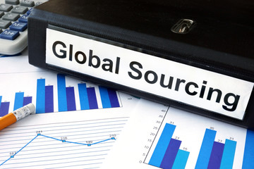 File folder with global sourcing and financial graphs. 