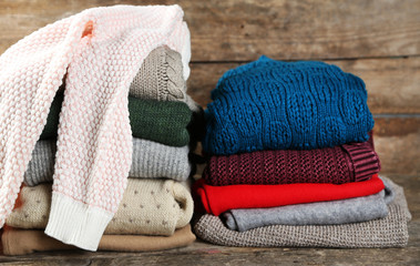 Knitting clothes on wooden background