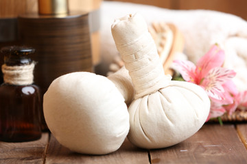 Beautiful spa composition with massage bags on table close up