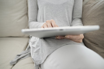 Women are looking at the tablet at home