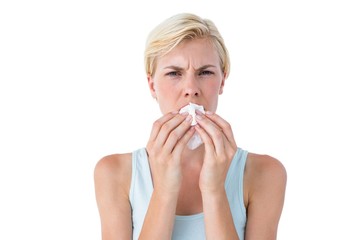 Attractive woman blowing her nose